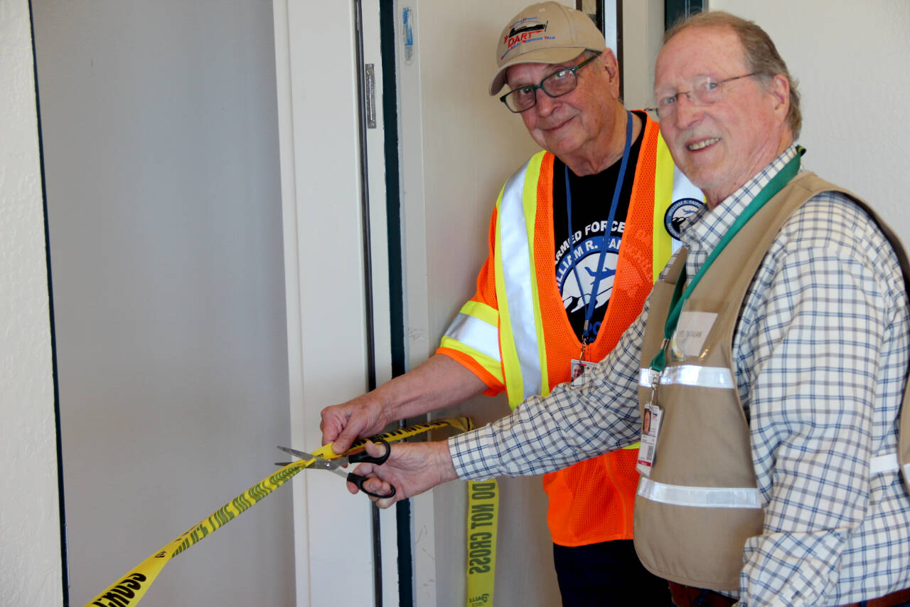 Photo courtesy of Clallam County Disaster Airlift Response Team / Alan Barnard, chair of Clallam County Disaster Airlift Response Team (DART) right, and David Woodcock, DART vice chair, cut the ribbon for the opening of the new DART Operations Center at Fairchild International Airport.