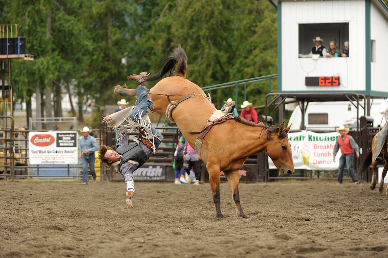 Sequim Gazette file photo by Matthew Nash / Cooper Wicks nearly makes the 8-second mark while bareback riding at the Clallam County Fair’s Rodeo in 2019.