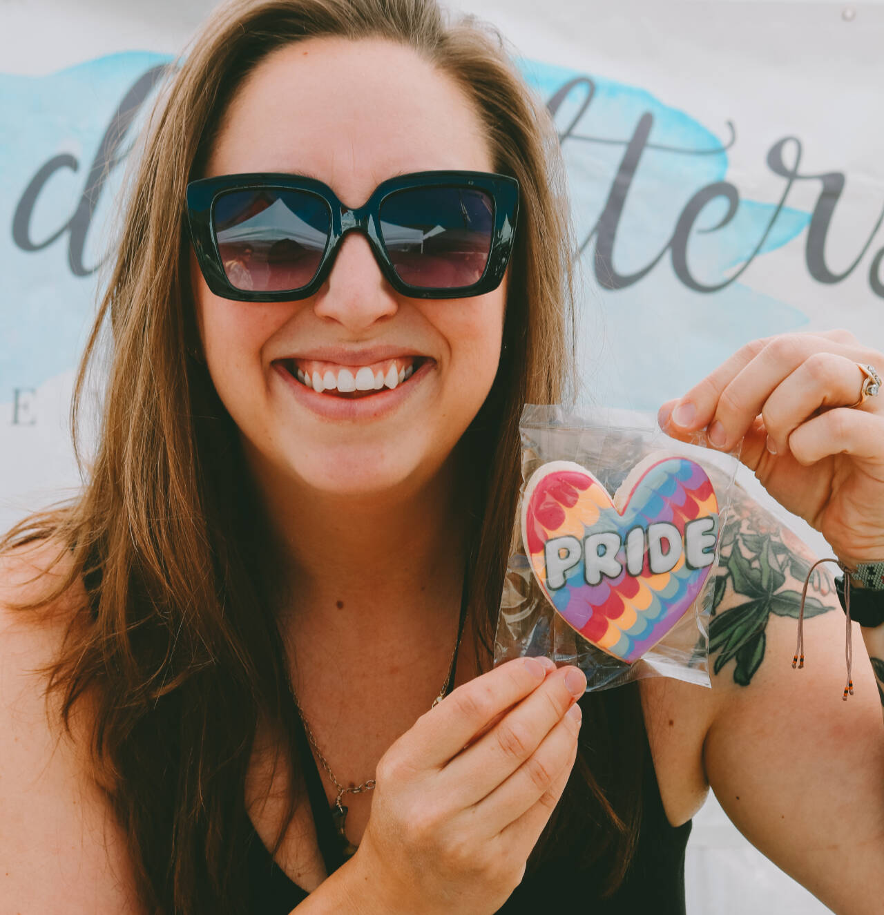 Photo courtesy of Sequim Farmers & Artisans Market
Sarah Harrington of Cookie Daughters holds one of her delicious, themed iced cookies for Pride Month.