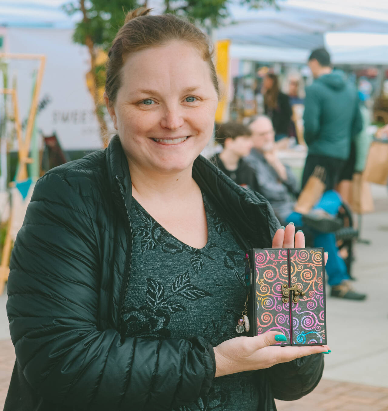 PhotoS courtesy of Sequim Farmers & Artisans Market 
Rose Crawford displays one of her one-of-a-kind composition notebooks at the Sequim Farmers & Artisans Market.