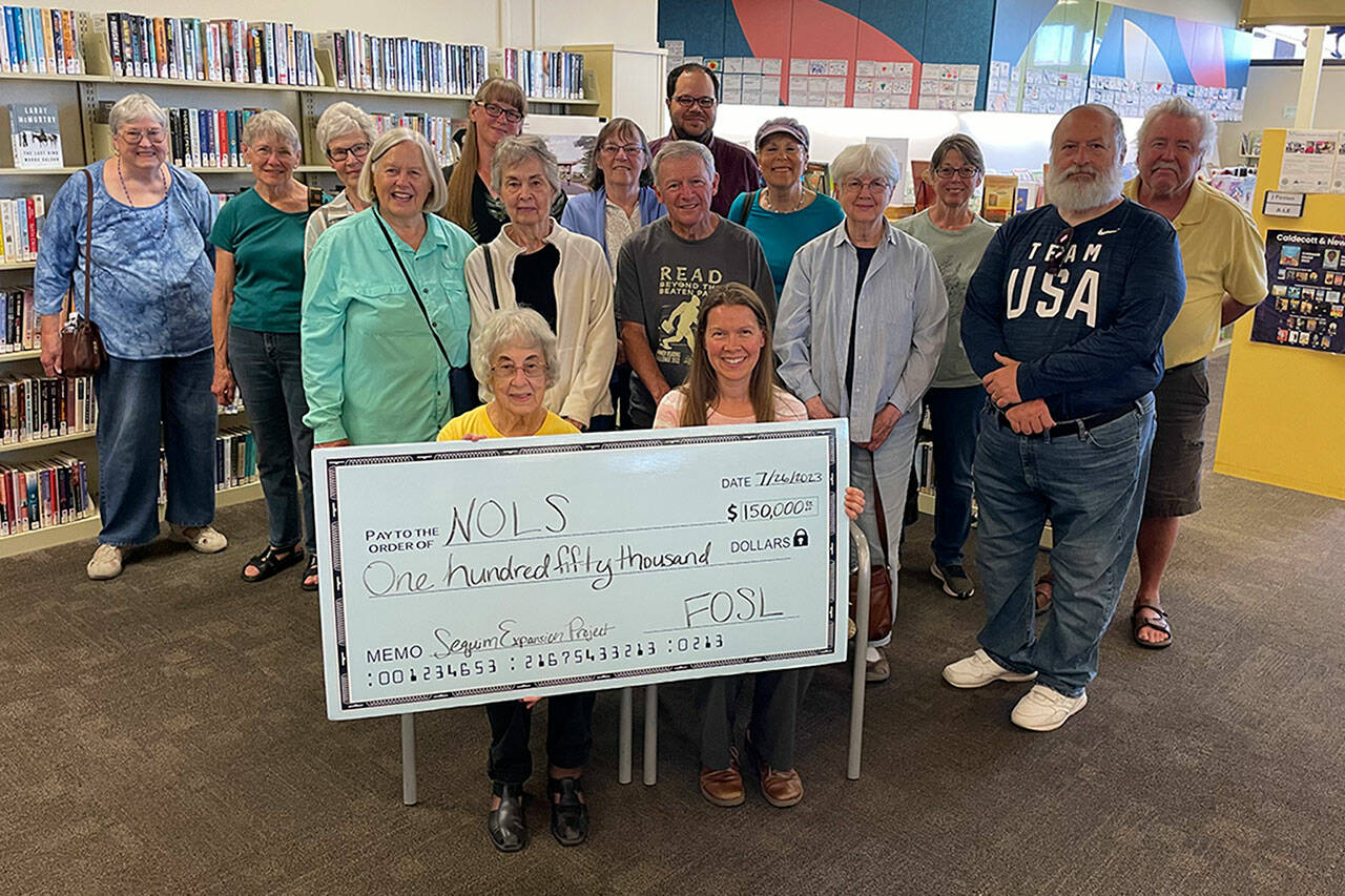 Sequim Gazette photo by Matthew Nash
Members of Friends of Sequim Library donate $150,000 on July 26 to the capital fund for the expansion and renovation of the Sequim Library project.