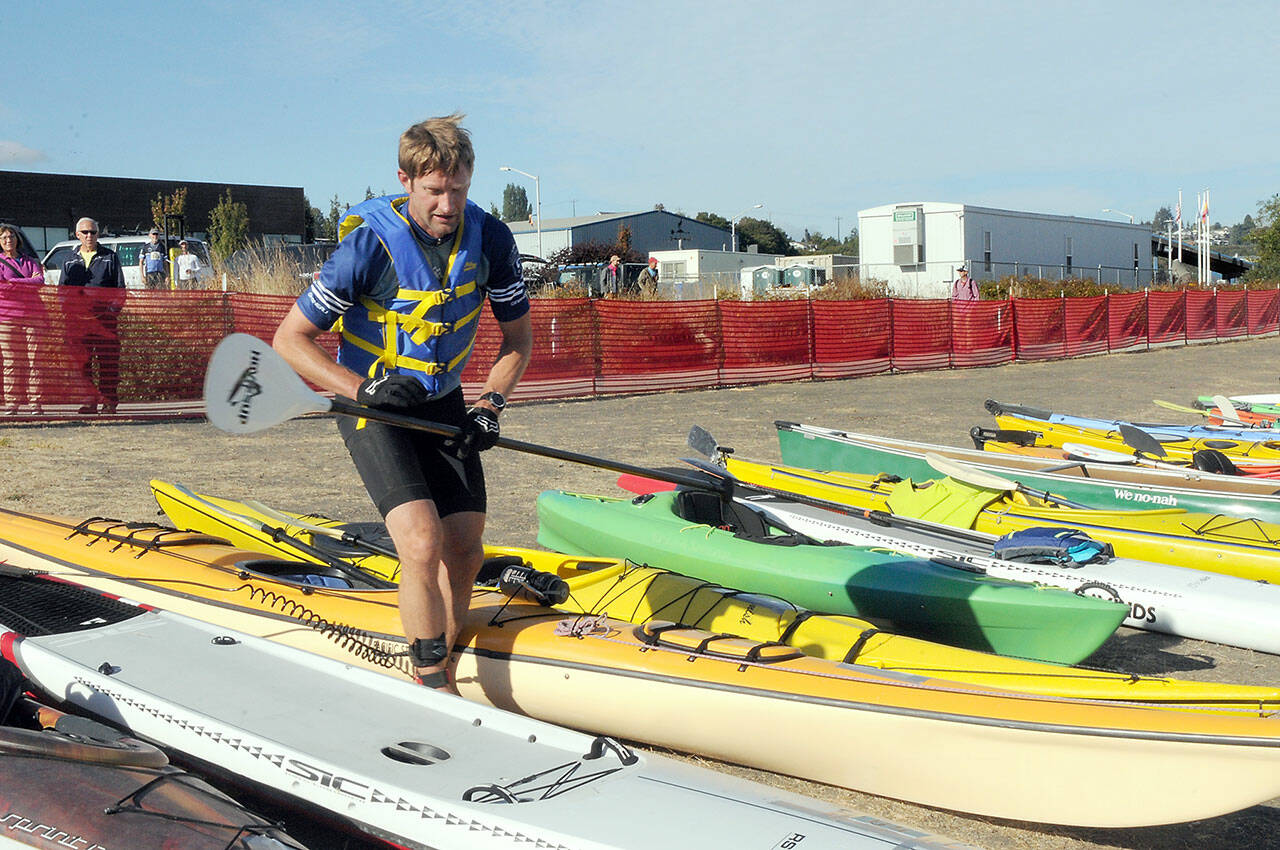 File photo by Keith Thorpe/Olympic Peninsula News Group / Ian Mackie of Gig Harbor prepares to launch his kayak from Pebble Beach as an iron man competitor during the Big Hurt in Port Angeles in 2022.