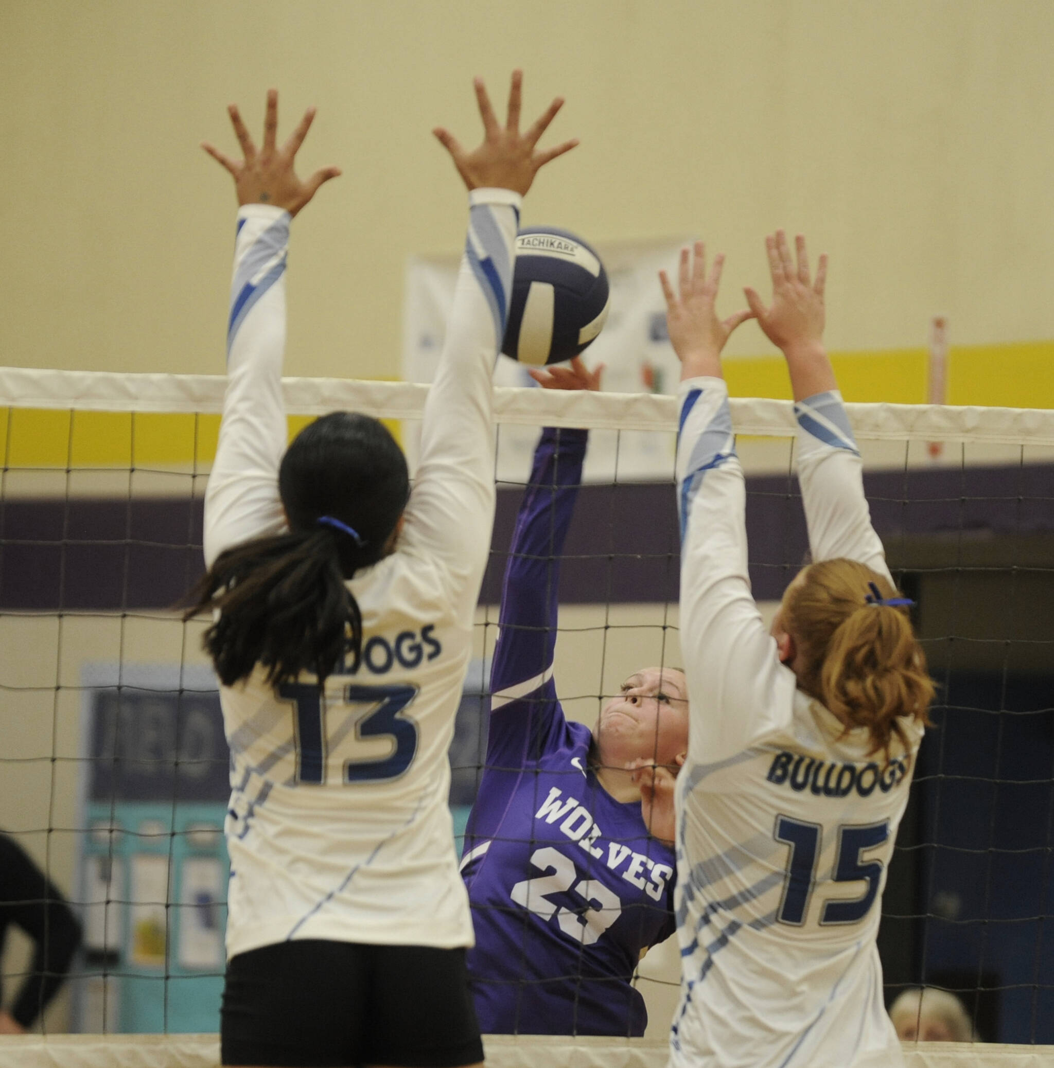 Sequim Gazette photo by Michael Dashiell / Sequim’s Kenzi Berglund tries to hit past North Mason’s Adrianna Tupolo (13) and Kalli Wynn (15) in the Wolves’ season-opener on Sept. 12. The Wolves topped North Mason in four sets.