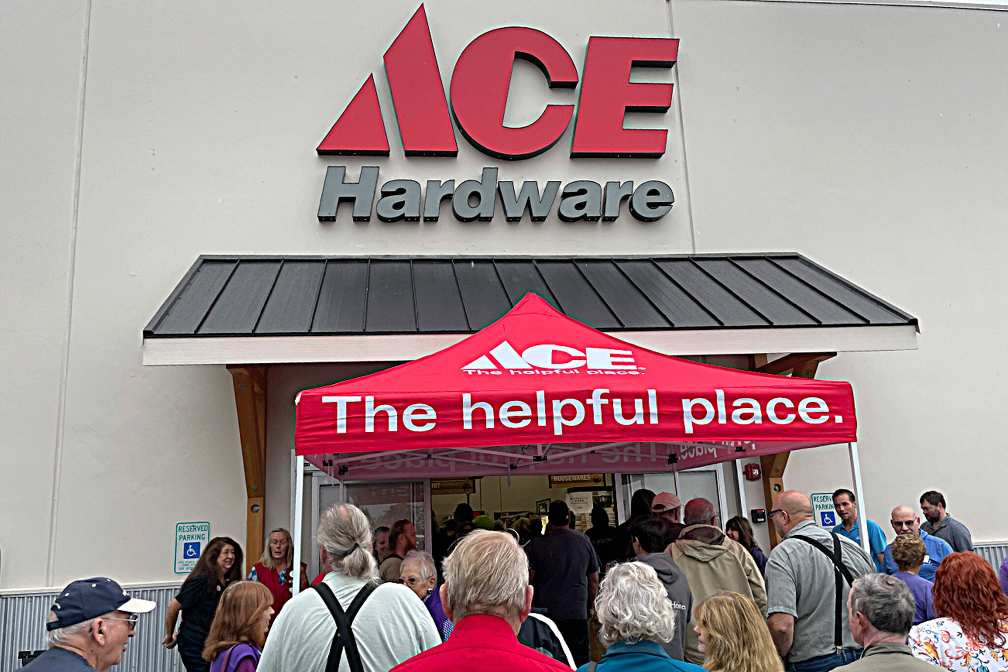 Sequim Gazette photo by Matthew Nash/ Doors opened for the Sequim Ace Hardware grand opening on Aug. 31 following ribbon cutting and sign sawing ceremonies.