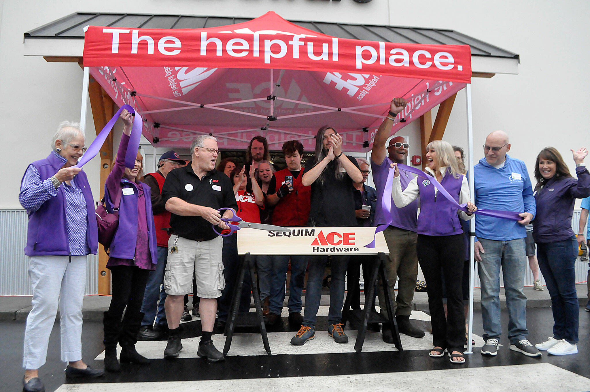 Sequim Gazette photo by Matthew Nash/ Store manager Bill McClansburgh cuts the Sequim-Dungeness Valley Chamber of Commerce’s ceremonial ribbon on Aug. 31 to commemorate the grand opening of Sequim Ace Hardware.