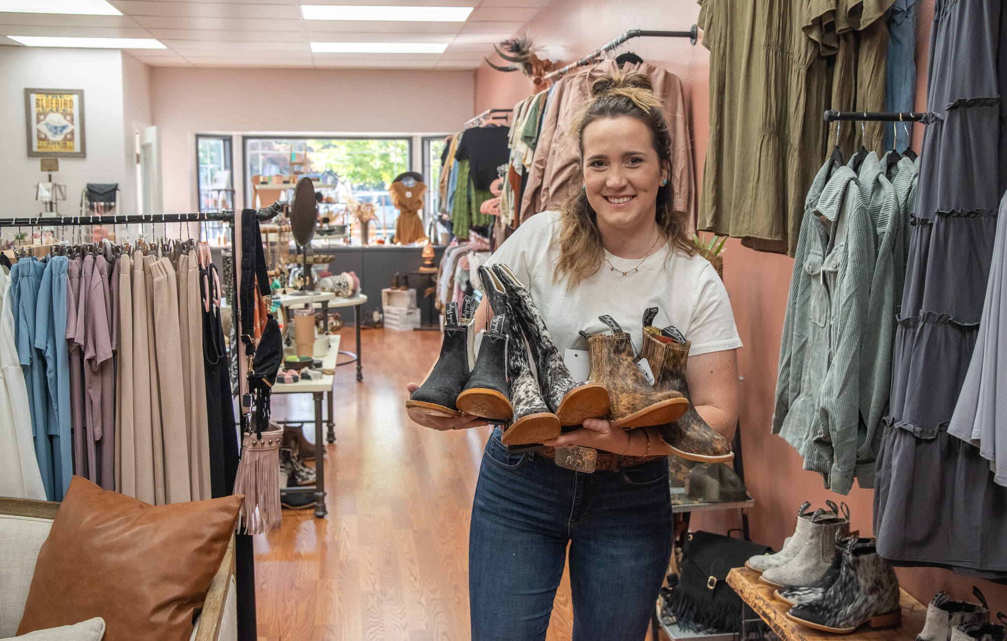 Sequim Gazette photoS by Emily Matthiessen
Kaila Martinez holds handmade cowboy boots for sale in her recently opened Western Wanderer Boutique on West Washington Street, next to Hurricane Coffee. Her clothing caters to all sizes and the boots are unisex.