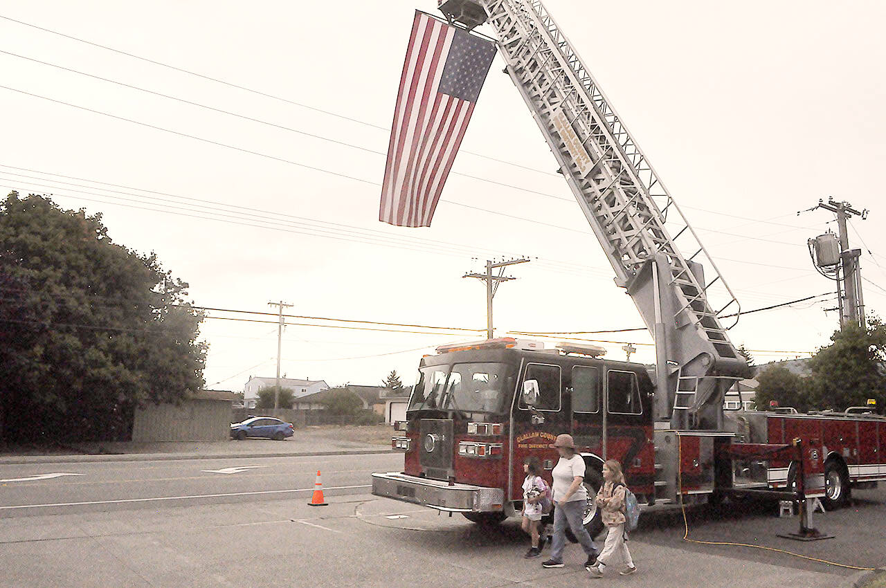 Sequim Gazette photo by Matthew Nash
A fire truck on Fifth Avenue displays an American flag on the 22nd anniversary of the 9/11 terrorist attacks.