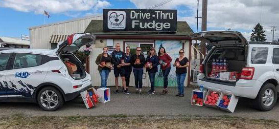 Photo courtesy of WeDo Fudge
Employees/staff with WeDo Fudge, Cascade Caramel and Clallam County Public Utility District No. 1 gather more than 450 pounds of peanut butter at their annual drive to donate to the Sequim Food Bank.