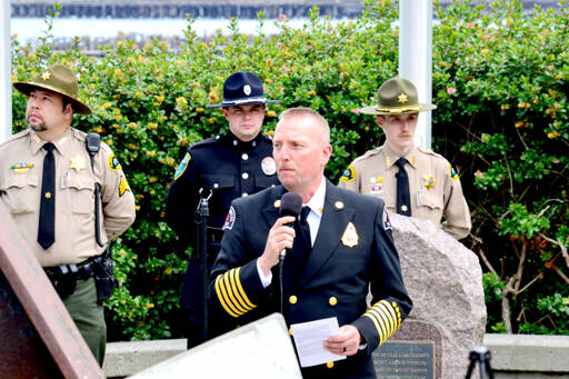 Port Angeles Fire Department Chief Derrell Sharp gives remarks at a ceremony commemorating the first responders who died in the Sept. 11, 2001, terrorist attacks at the 9/11 Memorial Waterfront Park in Port Angeles on Monday. (Peter Segall/Peninsula Daily News)