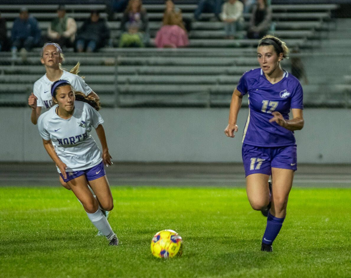 Sequim Gazette photo by Emily Matthiessen / Sequim’s Kaia Lestage, right, advances the ball in an Olympic League showdown with North Kitsap on Sept. 21.