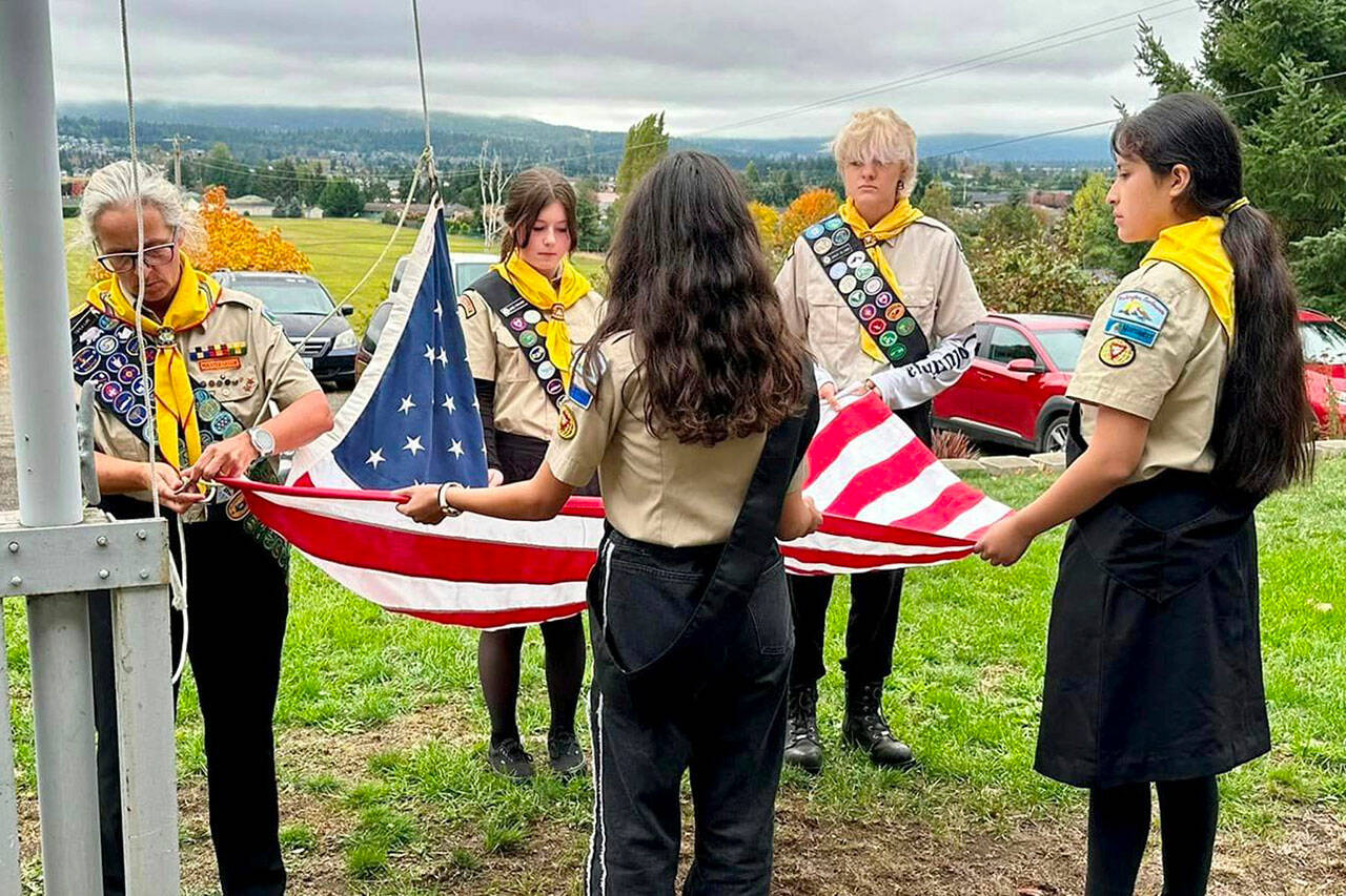 Photo courtesy Dr. Erika McClure
At a flag ceremony on Oct. 4, the Sequim Valley Pathfinder Club, from left, director Twyla Luke, Aimee Powless, Ella Luke, Zailey Allwine, and Jasmin Cortez prepare the American flag to fly at Peninsula Adventist Elementary School. A new light was installed to allow the flag to fly 24 hours a day.