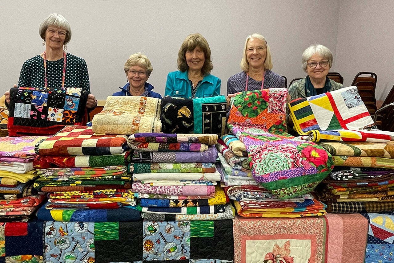 Sequim Gazette photo by Matthew Nash
Volunteers with Sunbonnet Quilt Club’s Community Quilts group donate 125 quilts to Sequim Community Aid’s Toys for Sequim Kids effort. Pictured for the donation were, from left, Mary Bess, Carmen O’Brien, Kathy Suta, president of Sequim Community Aid, Bonnie Cauffman, and Patricia Wood.