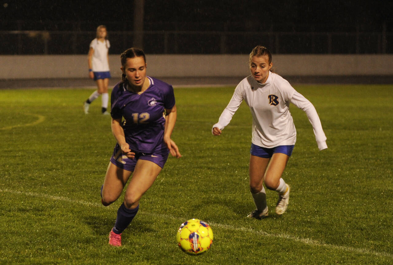 Sequim Gazette photo by Michael Dashiell
Sequim’s Olive Bridge, left, grabs possession of the ball and looks for a teammate in the first half of a 6-0 home win over Bremerton on Oct. 24.