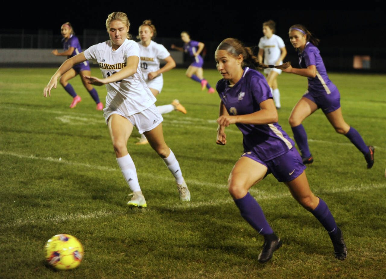 Sequim Gazette file photo by Michael Dashiell / With teammate Sasha Yada, left, racing into Spartan territory, Sequim’s Taryn Johnson looks to advance the ball against Bainbridge on Sept. 26. Johnson scored both goals in the 2-1 win, including the game-winner in double overtime.