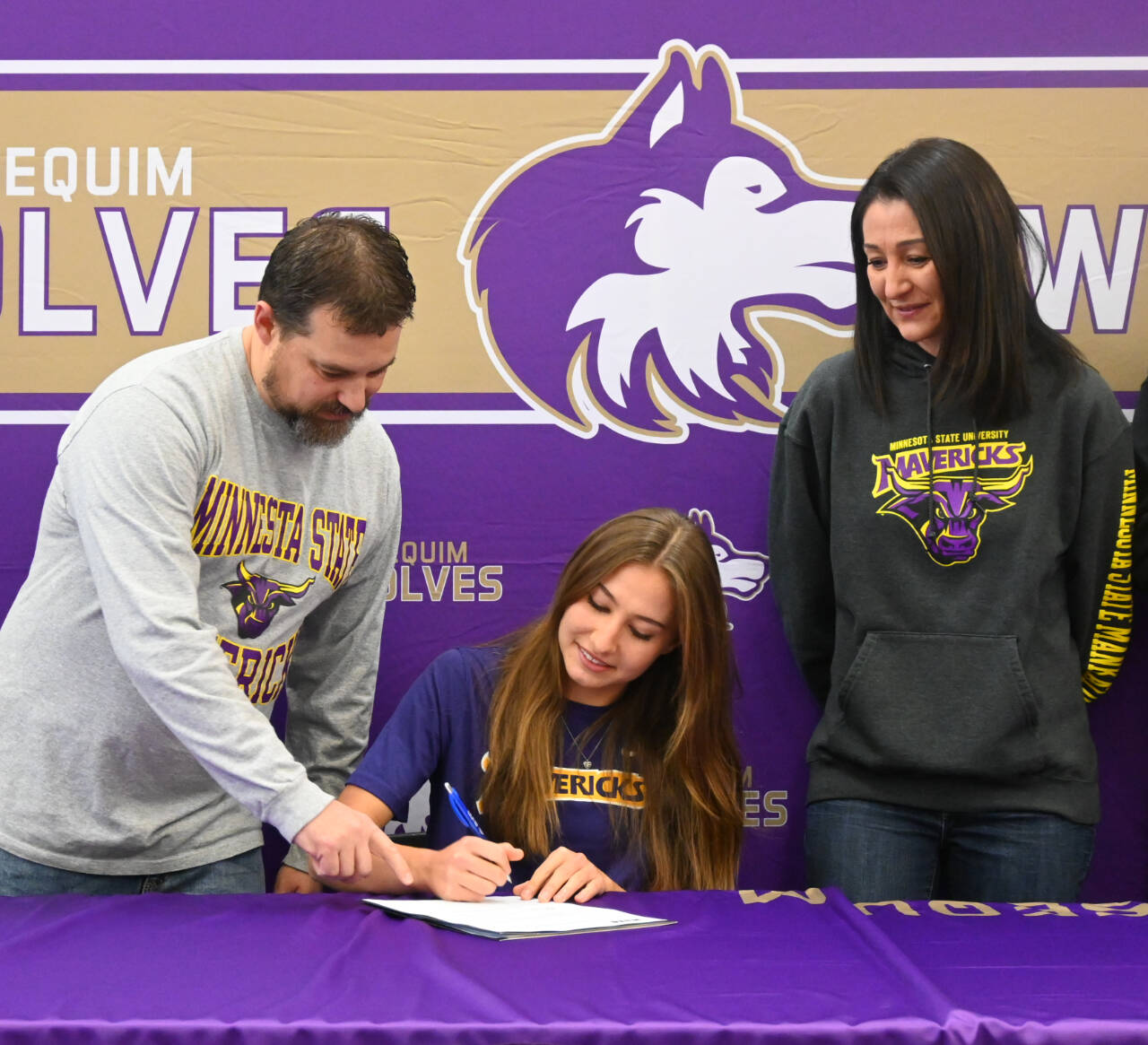Sequim Gazette photo by Michael Dashiell / With parents Travis and Kristen Johnson looking on, Sequim High School senior Taryn Johnson last week signs a letter of intent to play for Minnesota State University, Mankato.