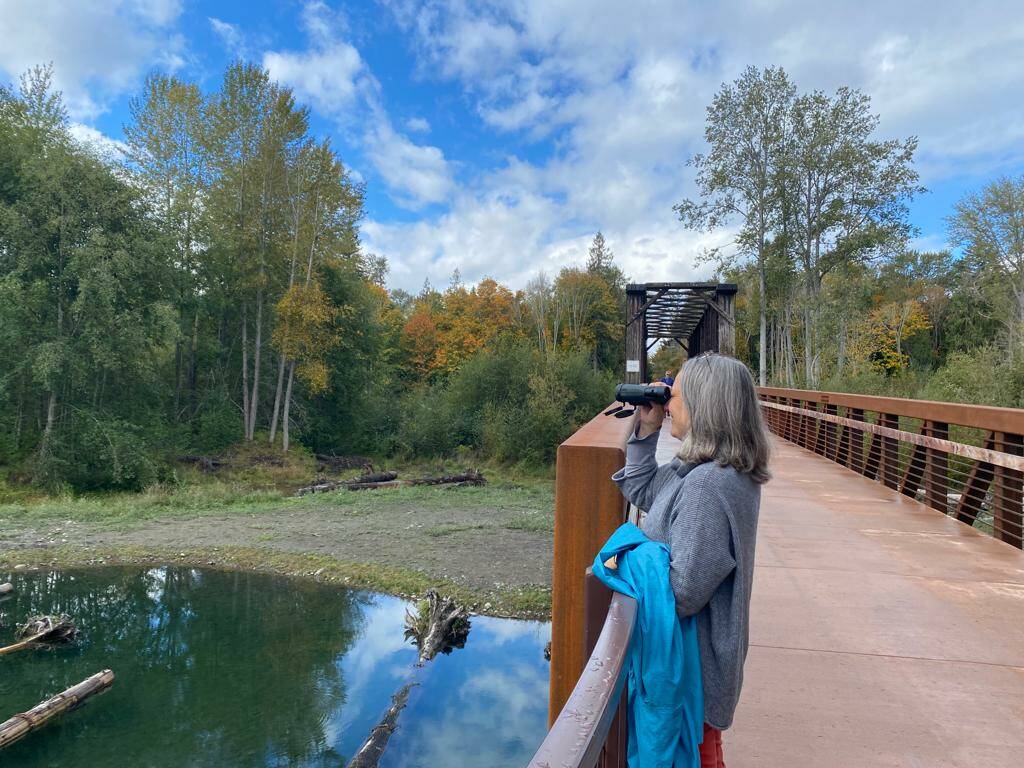 Photo courtesy of Teresa Smith
A visitor to the Dungeness River Nature Center uses binoculars donated by the family of Isaac Smith that bears on its strap a patch that honors the memory of the Sequim youth.