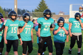 Photo courtesy of Sequim Middle School football / Sequim Middle School players (from left) Kaden Miller, Dalton Attwood, Samuel Thompson, Timothy Sealey and Max Sivilli get a breather during a break in play during a 2023 league contest.