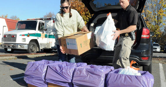 Helen Kenoyer of the Olympic Peninsula Community Clinic and Inspector Josh Ley of the Clallam County Sheriffs Office unload unwanted pharmaceuticals and medications from the agency at a drop-off point at the Clallam County Courthouse during Saturday's National Prescription Drug Take Back Day. At the event, people were allowed to get rid of unwanted or expired drugs for disposal in a safe and responsible manner. Additional drop-off points on Saturday were at Sequim City Hall and the QFC grocery store in Port Hadlock. Year-round drug disposal sites are kiosks at the Clallam County Sheriff's Office in Port Angeles, at the Sequim Police Department and through the Jefferson County Sheriff's Office in Port Hadlock. (Keith Thorpe/Peninsula Daily News)