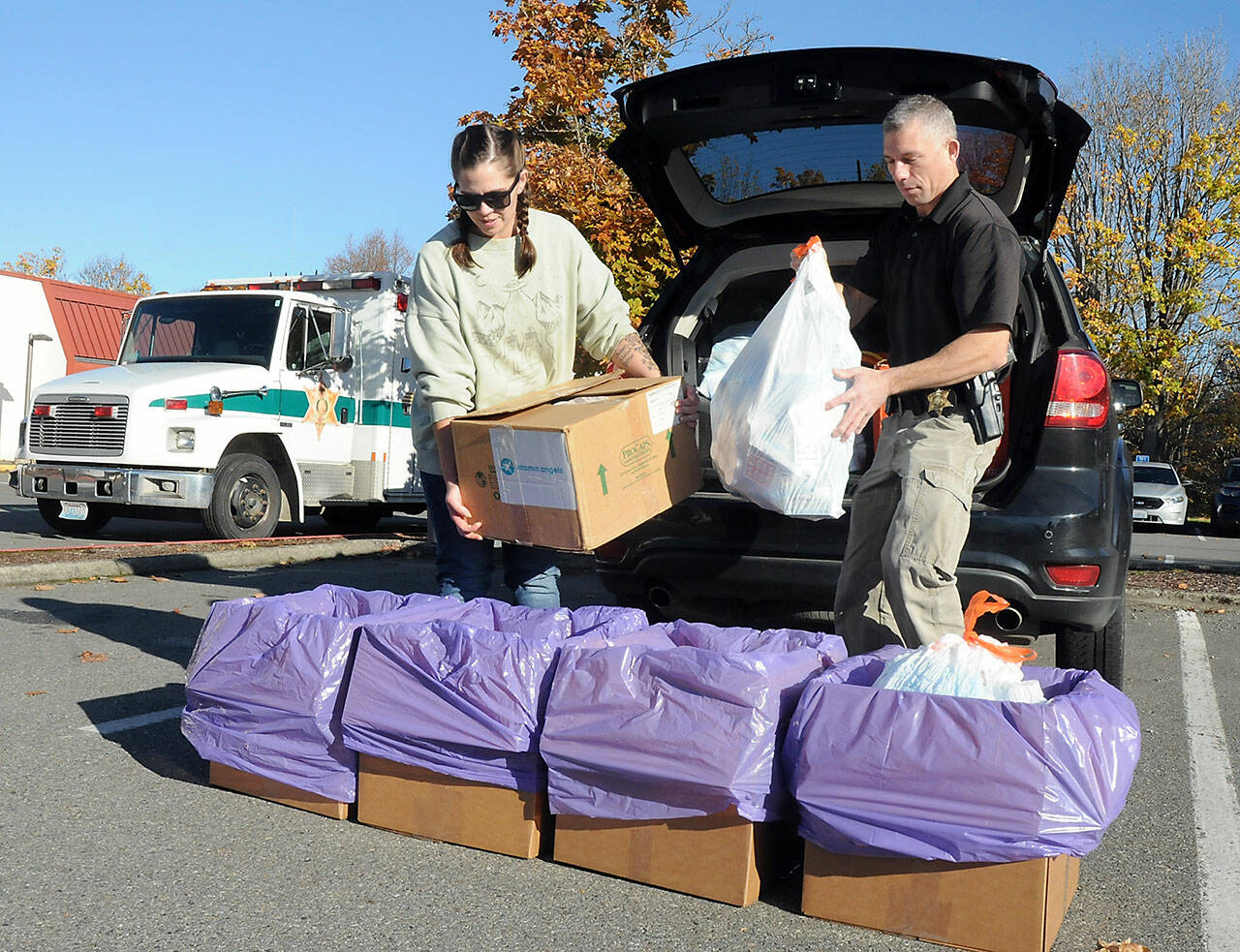 Photo by Keith Thorpe/Peninsula Daily News Group
Helen Kenoyer of the Olympic Peninsula Community Clinic and Inspector Josh Ley of the Clallam County Sheriffs Office unload unwanted pharmaceuticals and medications from the agency at a drop-off point at the Clallam County Courthouse during the National Prescription Drug Take Back Day on Oct. 28. At the event, people were allowed to get rid of unwanted or expired drugs for disposal in a safe and responsible manner. Additional drop-off points on Saturday were at Sequim City Hall and the QFC grocery store in Port Hadlock. Year-round drug disposal sites are kiosks at the Clallam County Sheriff’s Office in Port Angeles, at the Sequim Police Department and through the Jefferson County Sheriff’s Office in Port Hadlock.