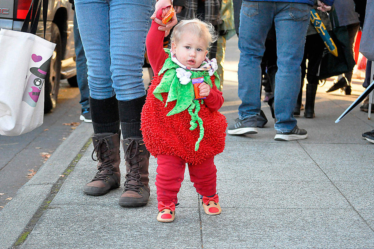 Thirteen-month-old Maggie Bagley trick-or-treats in downtown Sequim on Halloween with her mom and two older brothers.