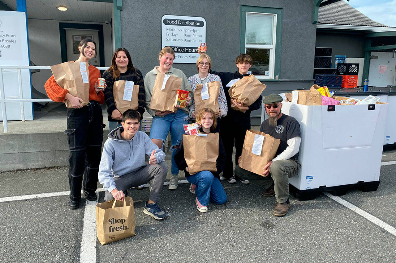 Photo courtesy of Heidi Krzyworz
Students continued the annual Boo Hunger food campaign this October. Some participants included, from top left, Emily Post, Melia Nelson, Skylar Krzyworz, Kimberly Heintz, Weston Owens; and from front left, Zachary Post, Kaitlyn Carpenter, and Andrew Zeppa, Sequim Food Bank warehouse manager.