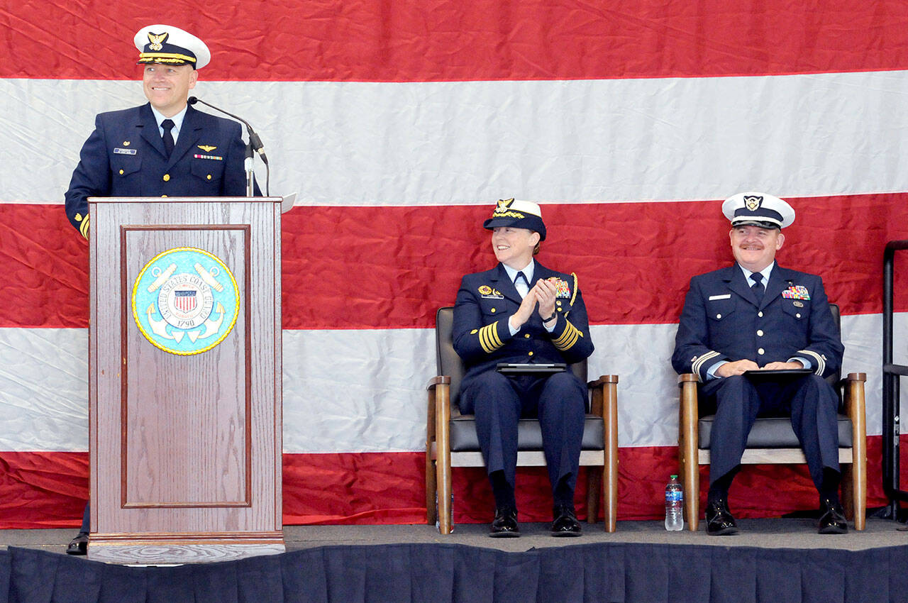 Photo by Keith Thorpe/Olympic Peninsula News Group
Cmdr. Brent Schmadeke, commanding officer of U.S. Coast Guard Air Station/Sector Field Office Port Angeles, left, introduces keynote speaker Capt. Holly Harrison of Coast Guard District 13, center, as Chaplain Mike VanProyen looks on during the Veterans Day program in Port Angeles on Nov. 11.