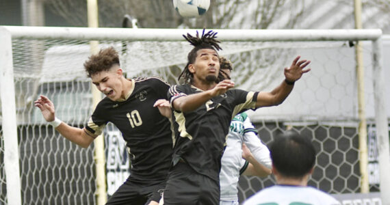Peninsula College's Nil Grau, left, and Abdurahim Leigh battle for a ball in front of the Highline net Sunday in Tukwila. (Jay Cline/Peninsula College)