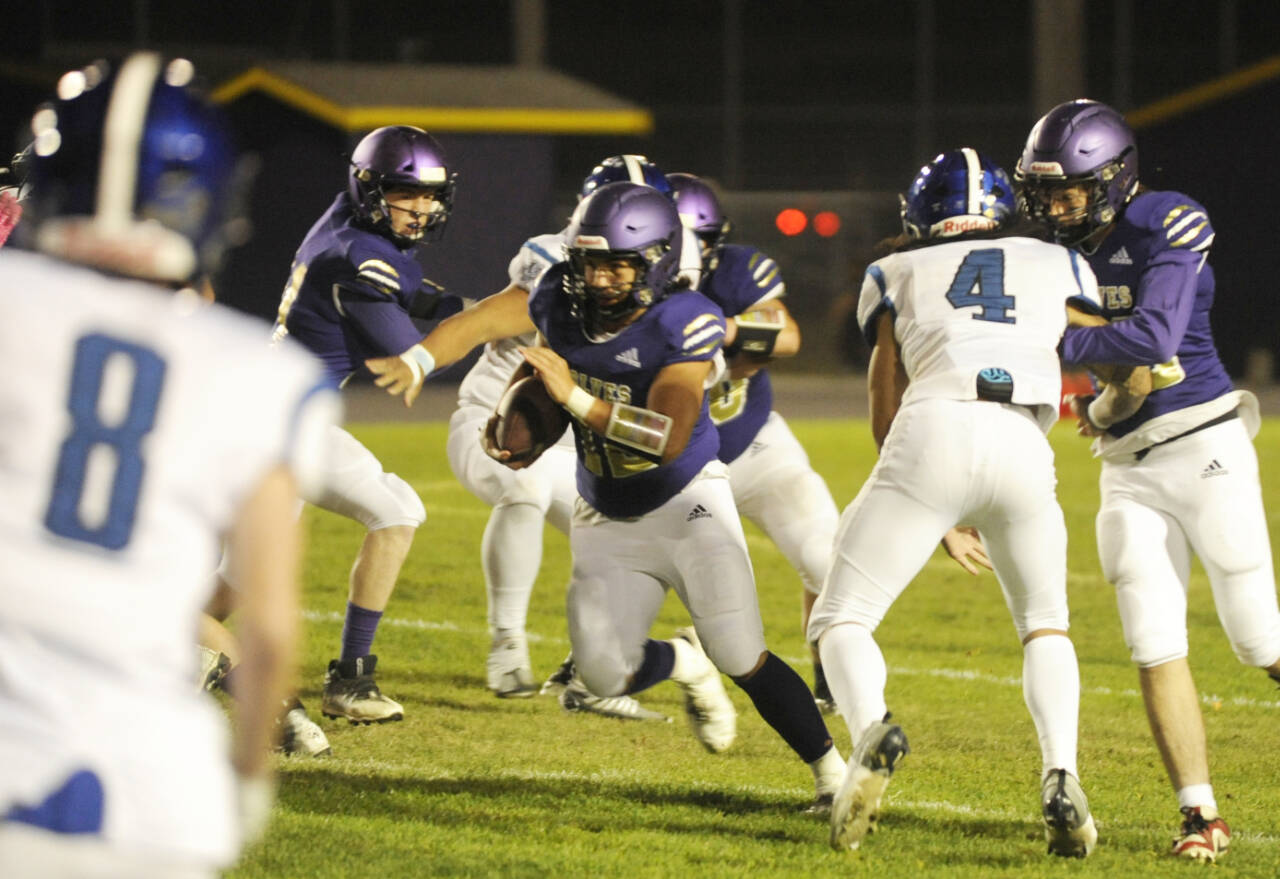 Sequim Gazette photo by Michael Dashiell / Sequim's Liam Wiker, center, finds a gaping hole in the North Mason defense in the second half of Sequim's 36-0 win on Oct. 13. Wiker led the team with 106 yards on 14 carries.