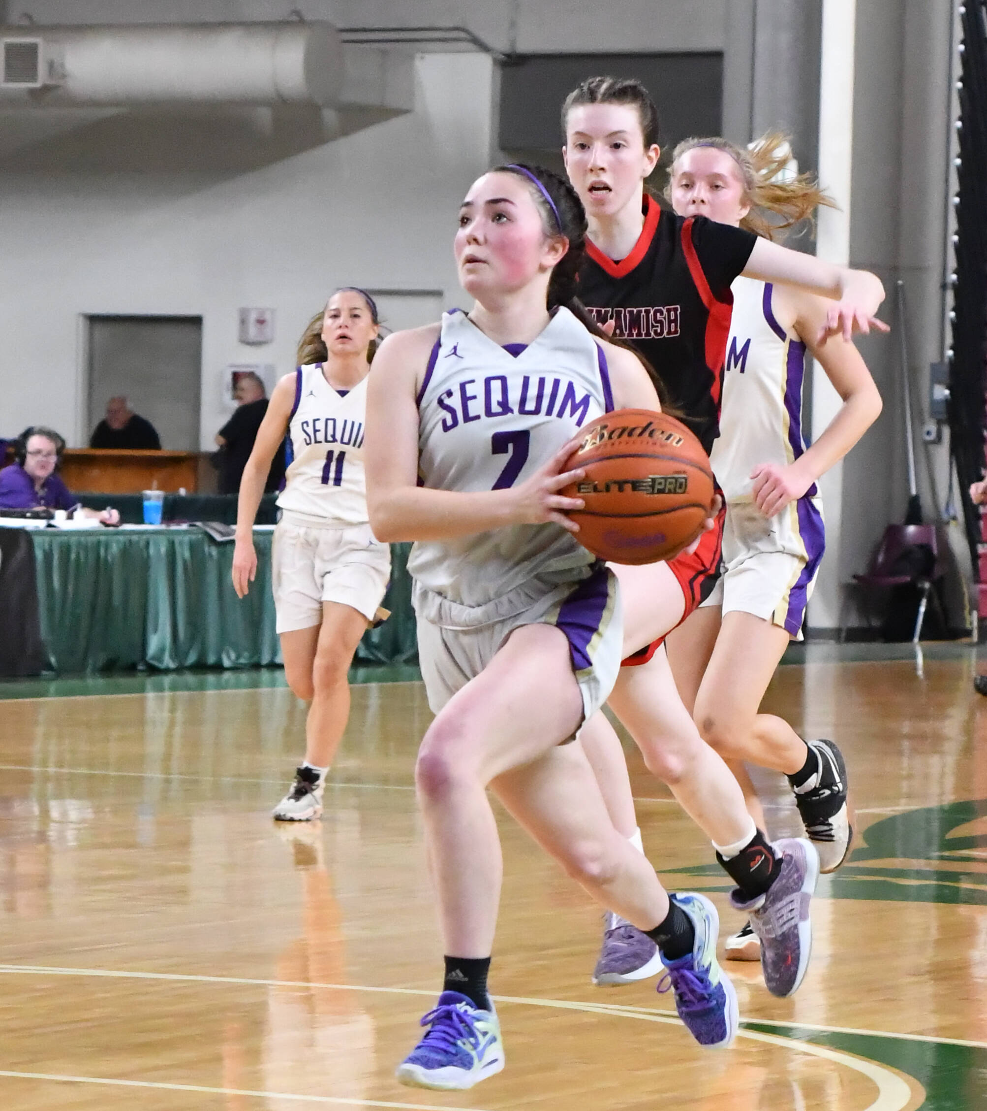 Photo by Jim Heintz / Sequim’s Hannah Bates leads a fastbreak in the first half of SHS’s 57-37 win over Sammamish at the class 2A state tournament in Yakima in March. Bates joins SHS teammate Jelissa Julmist on the Peninsula Pirates squad this winter.