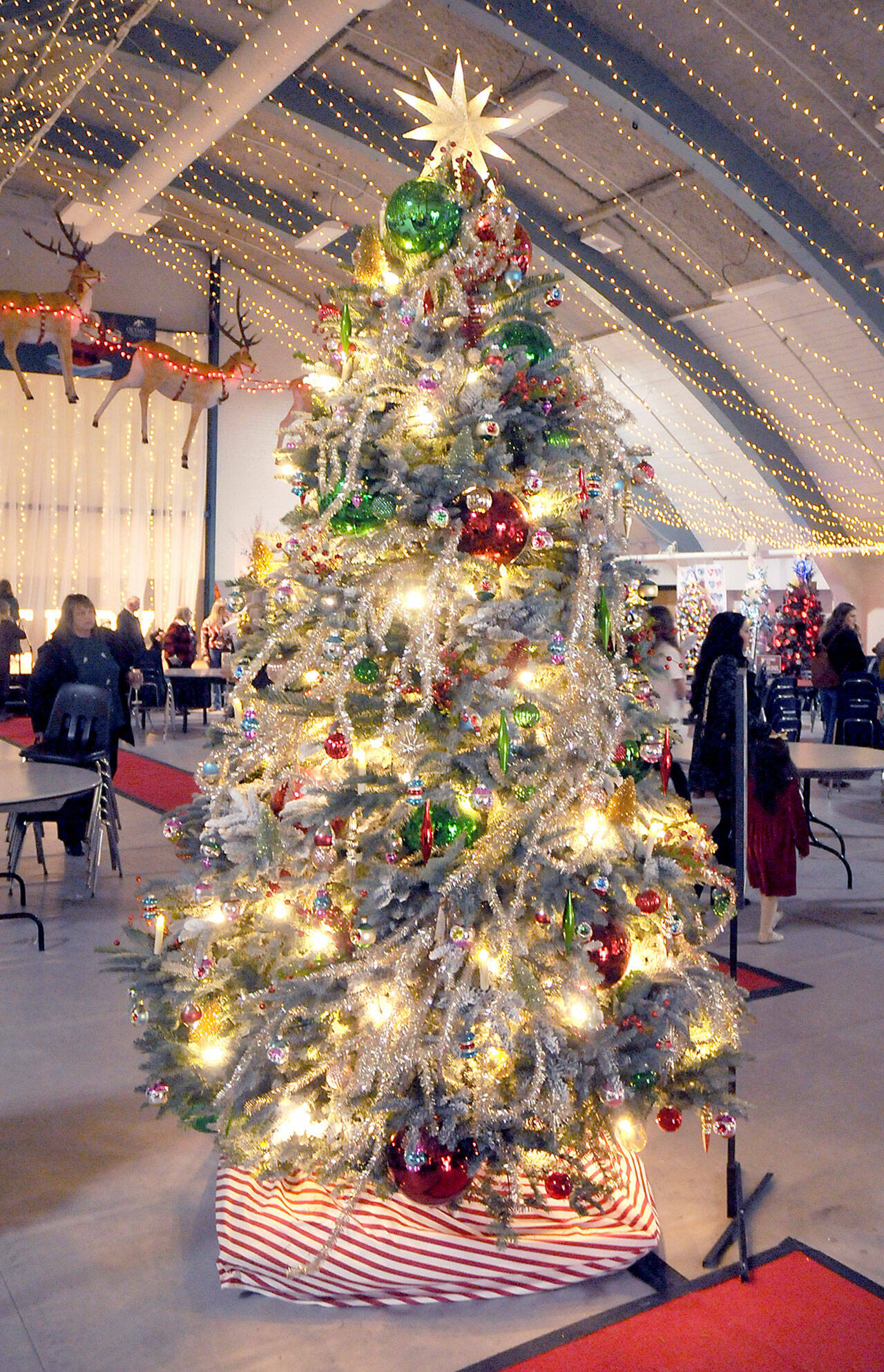 A decorated Christmas tree titled "Take Me Back" stands at Vern Burton Community Center in Port Angeles on Saturday after fetching the top bid of $7,500 offered by the Jamestown S'Klallam Tribe during Saturday night's Festival of Trees gala auction. The tree, designed by Staci Politik and sponsored by Applebee's Restaurant, included a $2,000 premium gift certificate for home furnishings from Angeles Furniture. More than 40 trees were auctioned off on Friday as a benefit for the Olympic Medical Center Foundation. (Keith Thorpe/Peninsula Daily News)