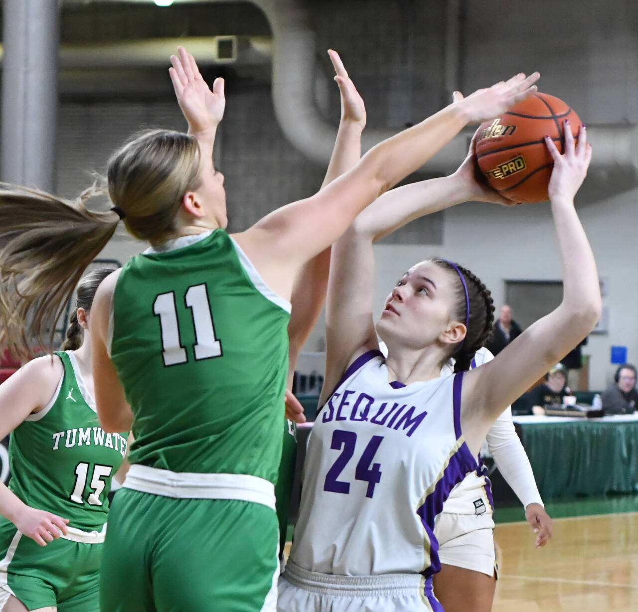 Photo by Jim Heintz / Sequim’s Dani Herman, right, looks to put up a shot over Tumwater’s Kylie Waltermeyer in the Wolves’ 38-24 win over Tumwater at the class 2A state tournament in March.