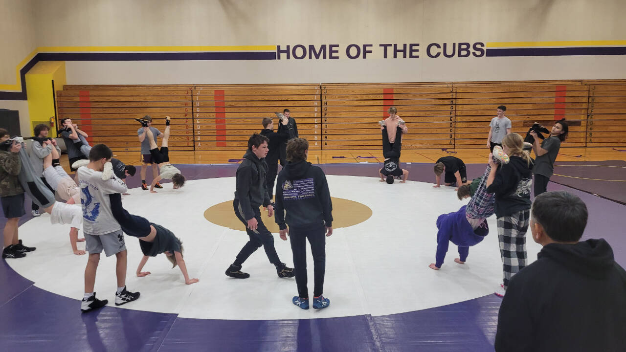 Sequim Gazette photoS by Michael Dashiell
Sequim High wrestlers do some modified pushups at a preseason practice at the SHS auxiliary/Olympic Peninsula Academy gymnasium last week.