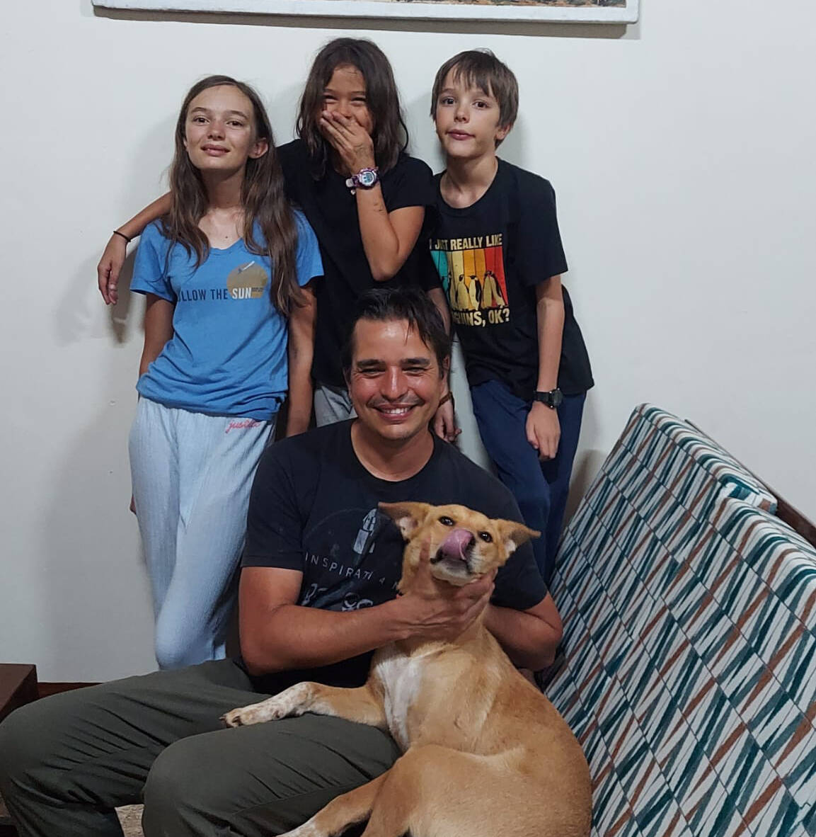 Photo courtesy of Kyle Johnson / The Johnson family  pictured are, from left, Josephine, Charlotte and Collin with dad Kyle with their new dog, Binti and (not pictured) mom Anna  adjusts to life in Africa.