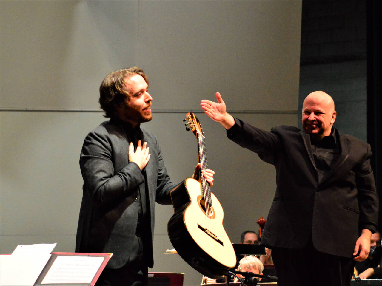 Photo by Diane Urbani de la Paz
Guitarist Colin Davin, left, stands beside Port Angeles Symphony conductor Jonathan Pasternack, immediately after stepping in at the last minute to perform with the orchestra in December 2021. Davin will rejoin the Symphony for its Holiday Concert this Saturday.