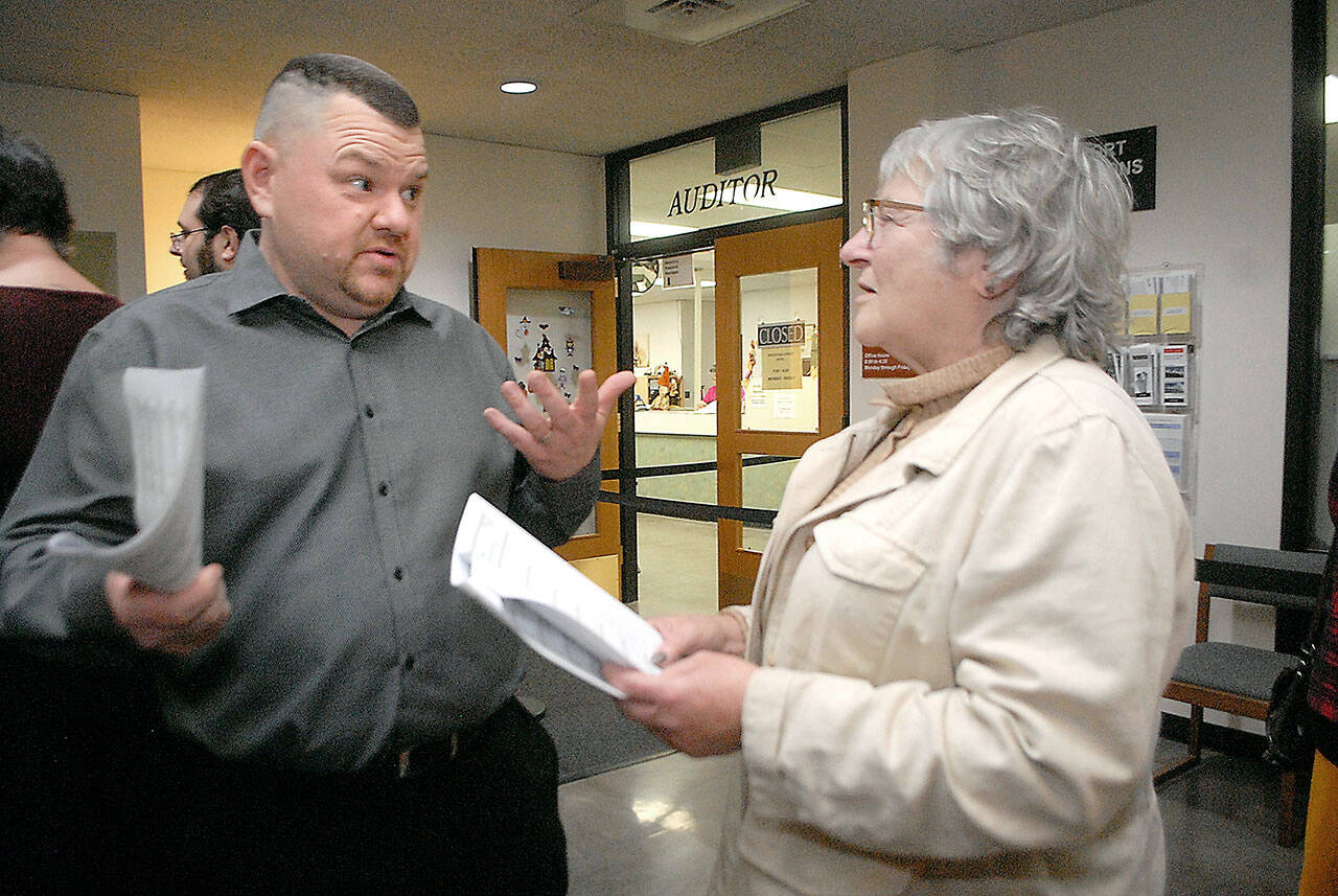 Photo by Keith Thorpe/Olympic Peninsula News Group Sequim School Board candidate Eric Pickens, left, speaks with incumbent Olympic Medical Center Board Member Jean Hordyke in the lobby of the Clallam County Courthouse on Election Night in Port Angeles in 2019.