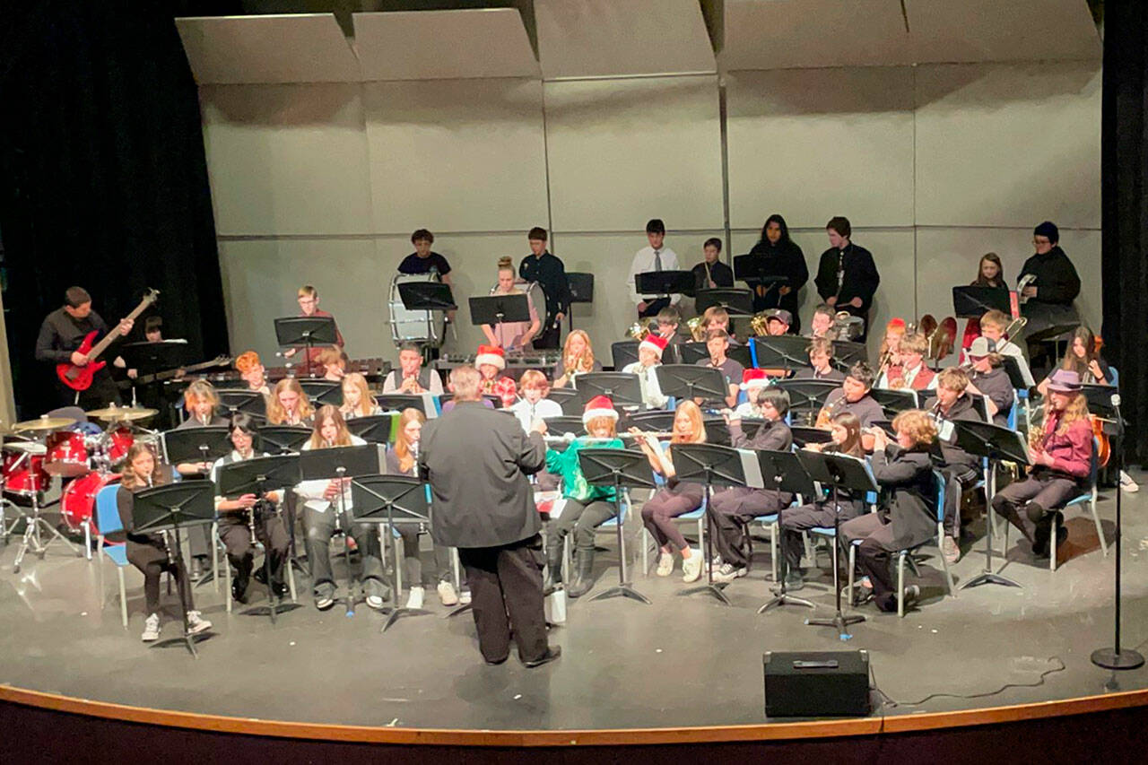 Sequim Gazette photo by Matthew Nash/ Seventh and eighth graders join together to play festive tunes at their joint holiday concert with other middle and high schoolers on Dec. 14.