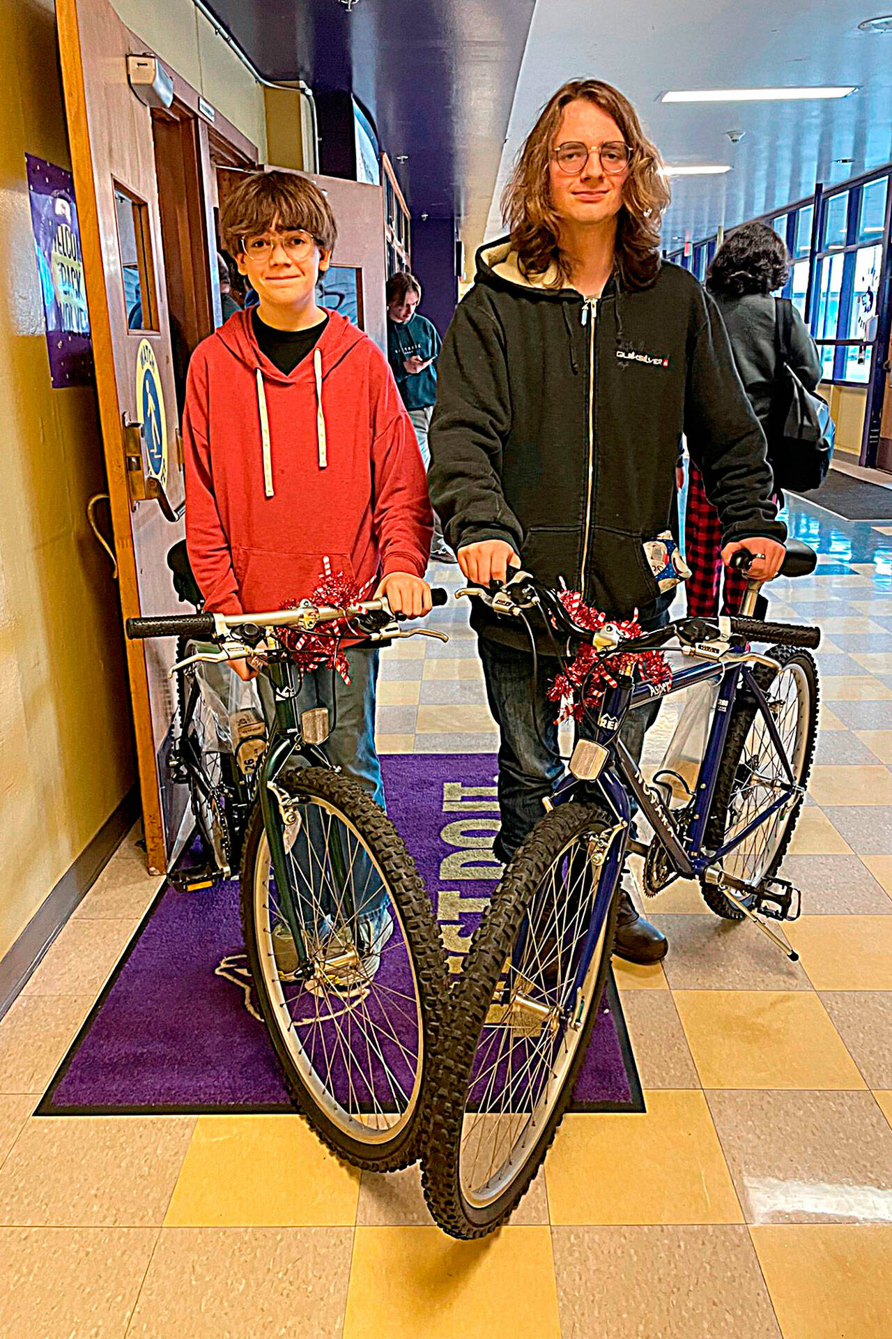 Sequim freshmen Nathan Mavy, left, and Kaydan Scouller were surprised to learn they were recipients of bicycles at Sequim High School’s Winter Wishes on Dec. 18. They both assumed a friend asked on their behalf. “I’m very confused and happy,” Mavy said. Both teens said they appreciated it a lot with Mavy saying his previous bike was stolen.