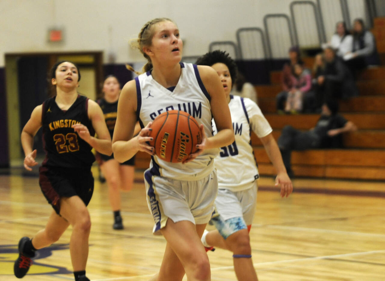Sequim Gazette photo by Michael Dashiell / Jolene Vaara drives to the basket for a score as teammate Bobbi Mixon looks on in the Wolves’ 51-41 home win over Kingston on Jan. 5.