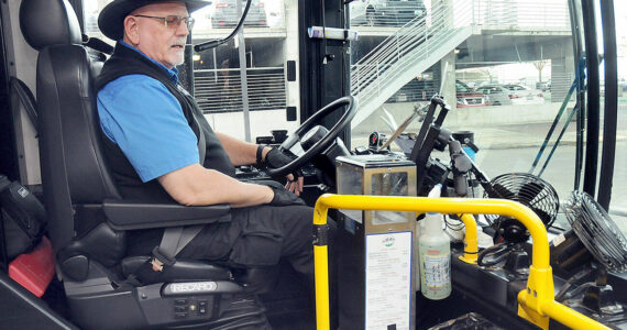 Clallam Transit driver Duane Benedict looks down at his fare box before departing The Gateway transit center in downtown Port Angeles on Saturday — the last day of collecting fares on most bus routes. (Keith Thorpe/Peninsula Daily News)