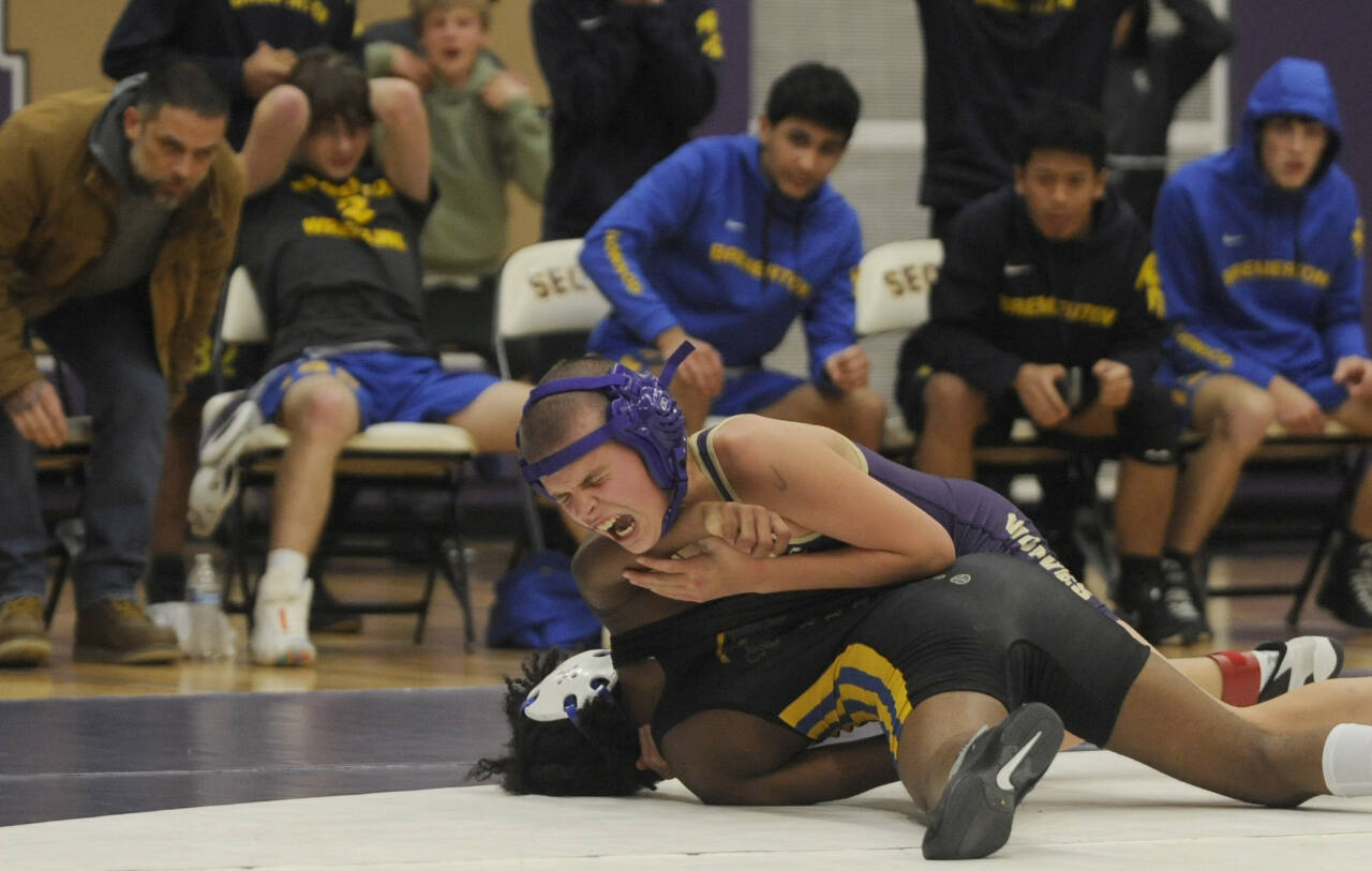 Sequim Gazette photo by Michael Dashiell
Sequim’s Brandon Bair, top, grapples with Bremerton’s Makhi Marion at 106 pounds. Bair’s come-from-behind pin in the match’s final round helped Sequim win by five points.