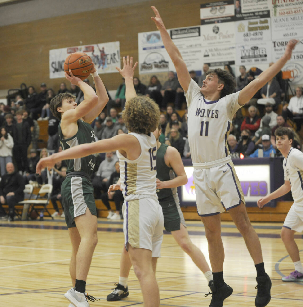 Sequim Gazette photo by Michael Dashiell / Sequim’s Charlie Grider, right, and Zeke Schmadeke look to pressure Port Angeles’ Parker Nickerson in the Wolves’ 77-52 loss to the visiting Roughriders on Jan. 11.