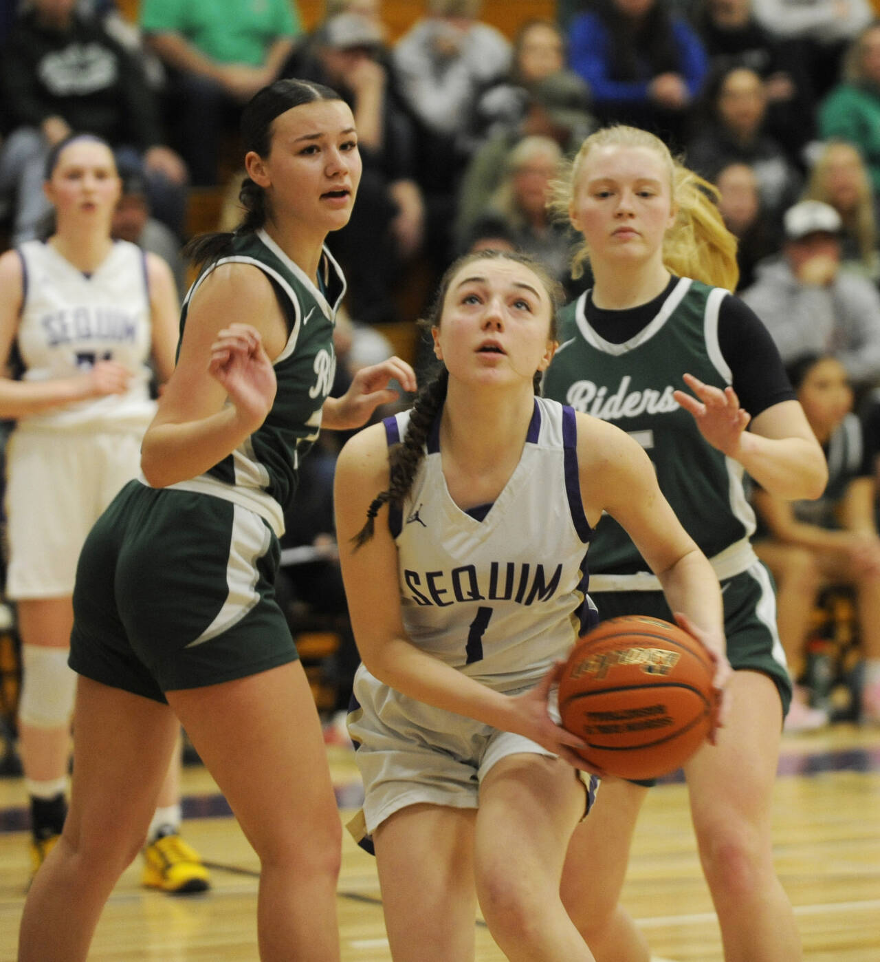 Sequim Gazette photo by Michael Dashiell
Sequim’s Taylor Heyting, center, looks to score as Port Angeles defenders Lexie Smith, left, and Paige Mason look on. PA’s Roughriders upended the host Wolves 66-64 on Jan. 11.