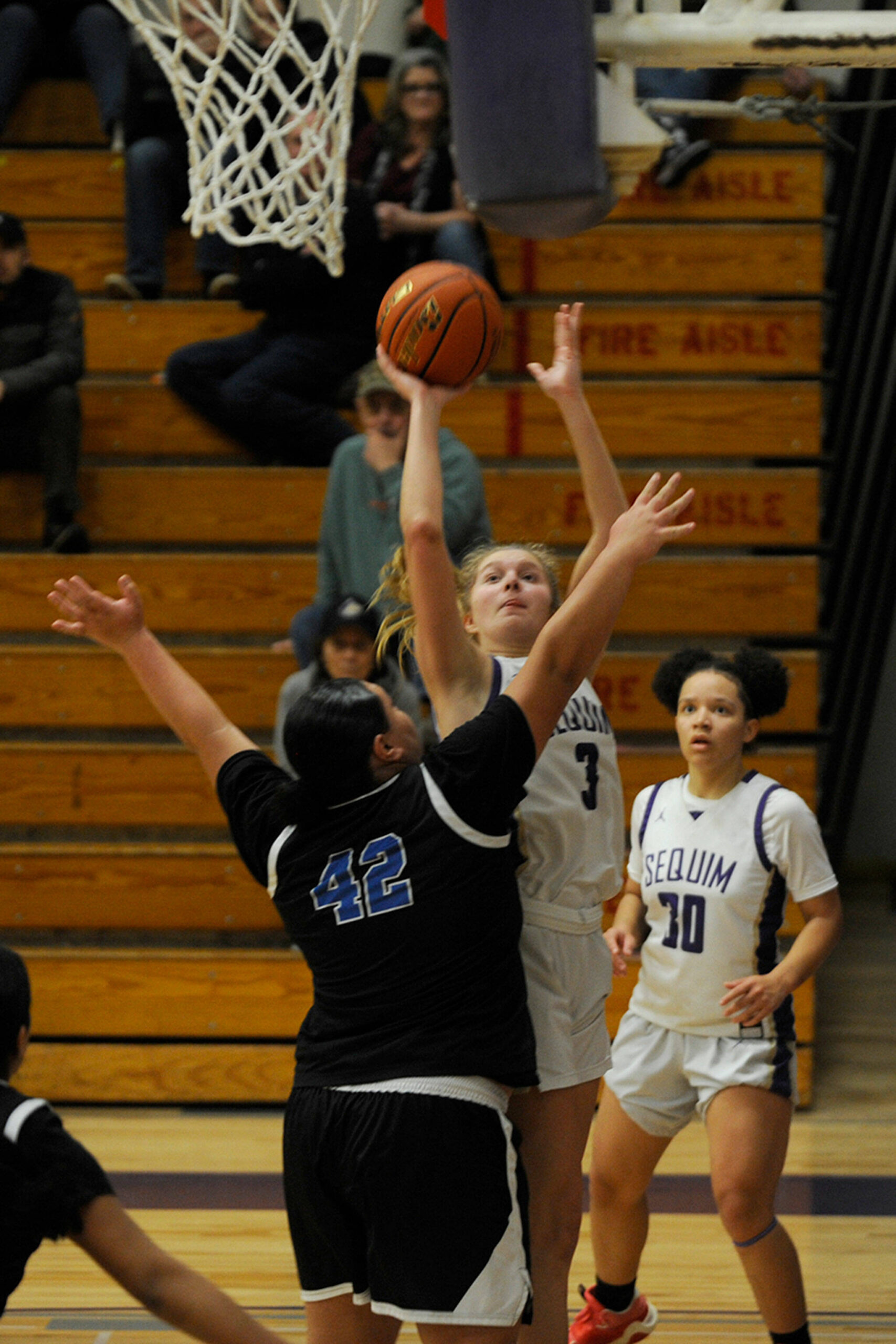 Sequim Gazette photo by Matthew Nash
With teammate Bobbi Mixon (right) looking on, Sequim’s Jolene Vaara goes up for a shot after grabbing an offensive rebound over North Mason’s Tanza Tupolo in an Olympic League match-up on Jan. 26.