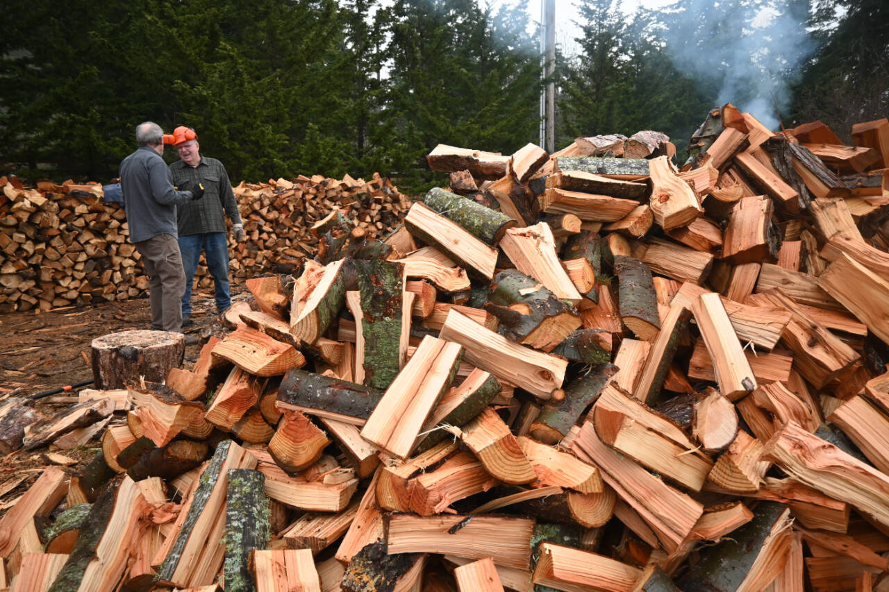 Sequim Gazette photo by Michael Dashiell / Ron Long, left, and Jack Tatom chat in a rare break between cutting wood for their group’s efforts to help the Path From Poverty nonprofit.