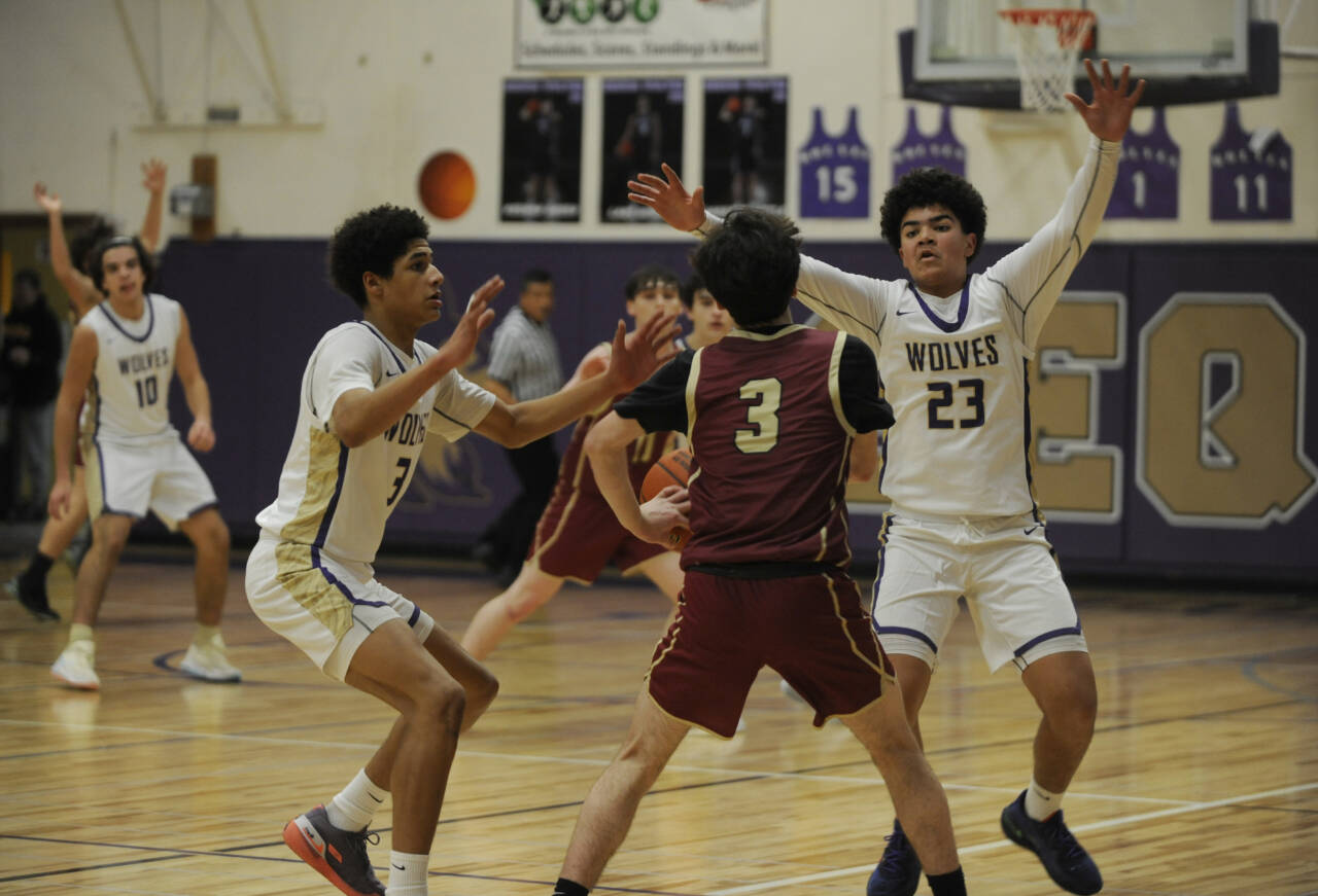 Sequim Gazette photo by Michael Dashiell
Sequim’s Solomon Sheppard, left, and Jericho Julmist guard Kingston’s Jace Brady in a 63-50 Wolves win on Jan. 26.