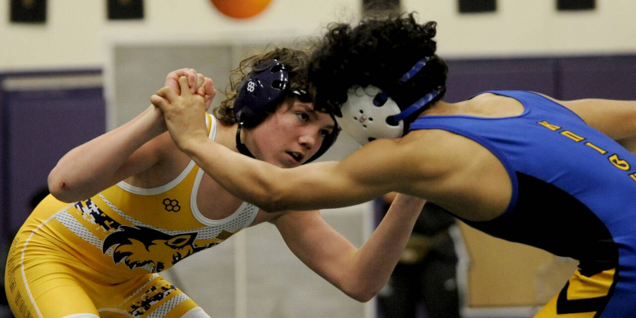 Sequim Gazette photo by Michael Dashiell / Ryan Spelker of Sequim, left, grapples with Anthony Murphy of Bremerton in the 120-pound weight class sub-regional title match in Sequim on Feb. 3. Spelker finished second and earned a spot at the Region 2 tourney this week.