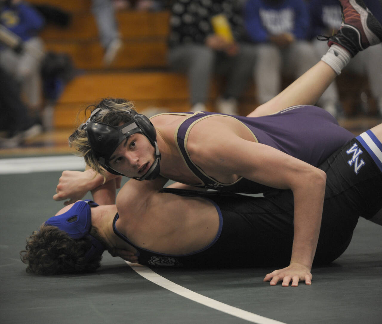 Sequim Gazette photo by Michael Dashiell / Sequim’s Jayms Vilona, top, works for a technical victory over North Mason’s Michael Freemier in the 144-pound weight class quarterfinals of a sub-regional tournament in Sequim on Feb. 3. Vilona placed second in the tourney.