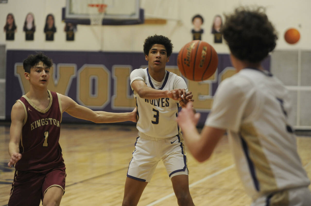 Sequim Gazette photo by Michael Dashiell / Sequim's Solomon Sheppard, center, passes to teammate Garrett Little as Kingston's xxxxxx (1) guards the play in a 63-50 win over the Buccaneers on Jan. 26.