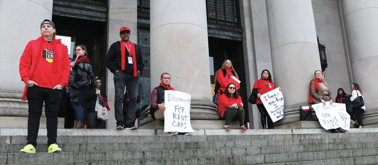 Photo by Mary Murphy/Washington State Journal / Protestors gather at the top of the Capitol’s North steps, among them Vancouver residents Jeremy Hopkins of SeaMar Community Health Services and Duana Johnson from Washington Low Income Housing Alliance.
