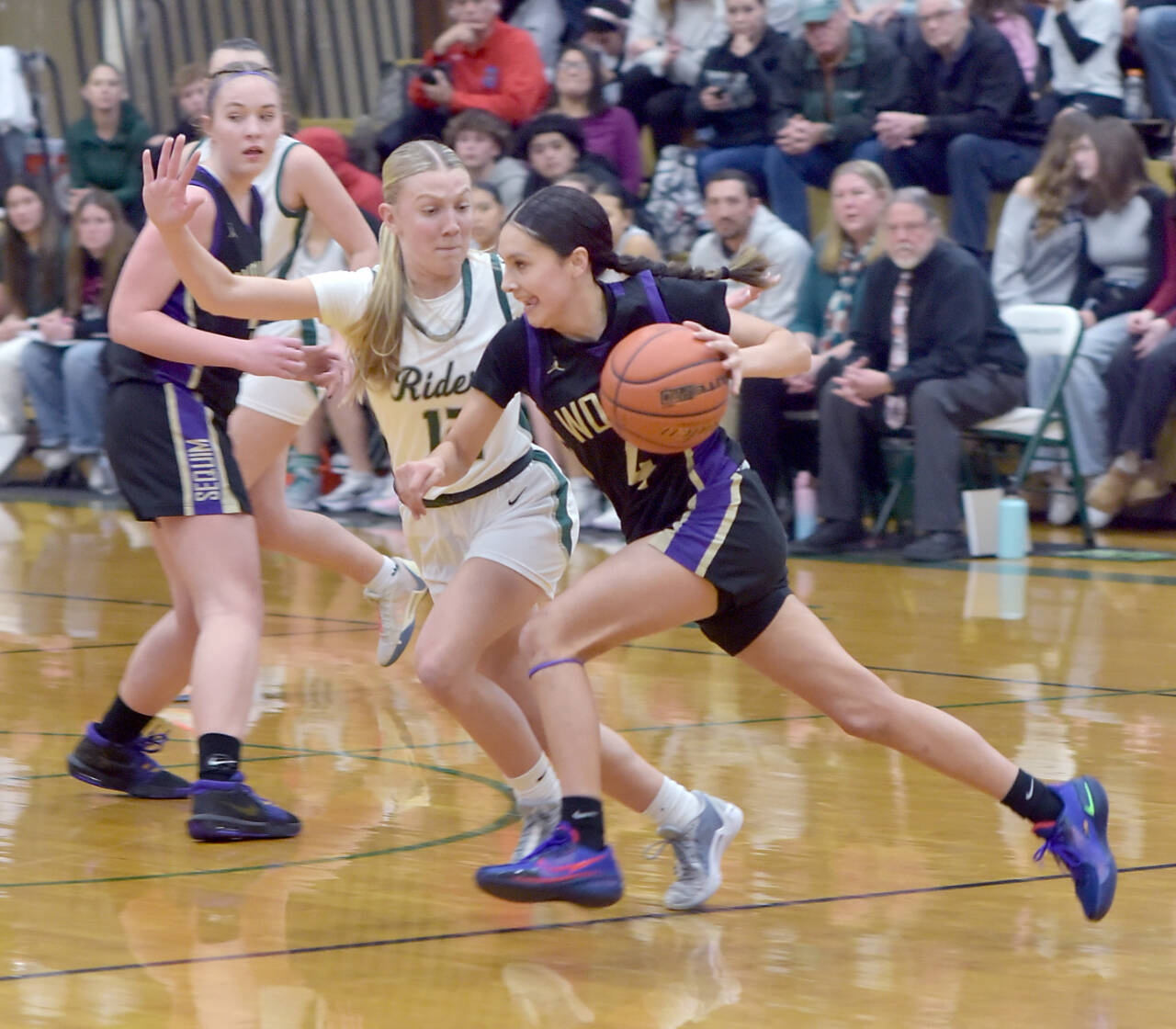 Photo by Keith Thorpe/Olympic Peninsula News Group
Sequim’s Graciela Chartraw, front, drives past Port Angeles’ Izzy Felton as teammate Hailey Wagner looks on during a Feb. 6 match-up in Port Angeles.